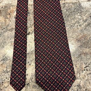 J.Crew silk tie in a dark blue, red, and beige plaid pattern.